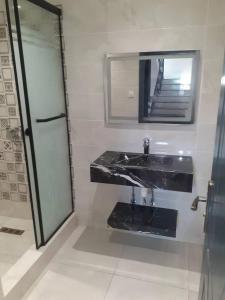 a bathroom with a black sink and a mirror at Le gîte in Tefeschoun +35 photos