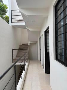 an empty hallway of a building with stairs and windows at Casa Flor in San Antonio de la Cal