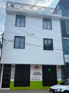 a building with a car parked in front of it at Casa Flor in San Antonio de la Cal