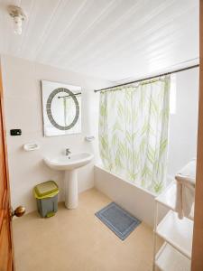 a bathroom with a sink and a shower curtain at 1 Sol Dominicus Solo Adultos Habitación con Entrada Independiente y Baño Privado in Bayahibe