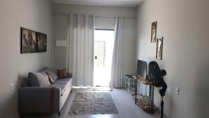 a living room with a couch and a television at Lar doce lar in Paragominas