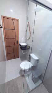 a bathroom with a toilet and a sink and a door at Lar doce lar in Paragominas +35 photos