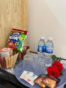 a table topped with two bottles of water and flowers at Tân Hiệp 2 Hotel in Bùi Tiếng