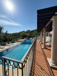 a balcony with a swimming pool on a house at Adriatic Monte Apartments in Tušupi