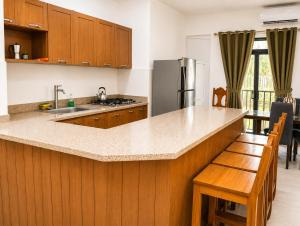 a kitchen with wooden cabinets and a counter top at Estudio Frente al Mar Solo Adultos in La Laguna
