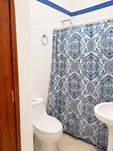 a bathroom with a toilet and a shower curtain at Estudio Frente al Mar Solo Adultos in La Laguna
