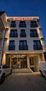a building with a sign that reads cure hotel at Euro Hotel in Peje