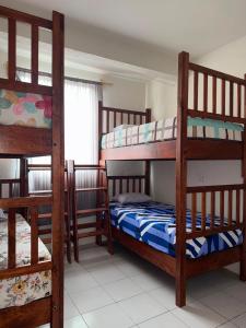 a room with three bunk beds and a window at Casa Flor in San Antonio de la Cal +9 photos
