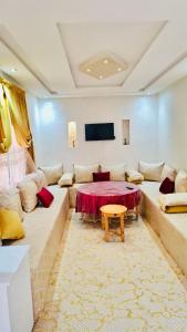 a living room with a couch and a table at Villa à Marrakech in Oulad Sidi Cheïkh