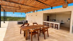 a kitchen and dining room with a table and chairs at Mayan View Walk to Beach & Tulum Ruins in Tulum