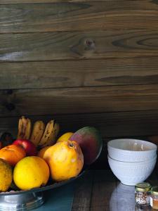 a bowl of fruit sitting on a table next to a plate at Recanto Duas Rosas in Venda Nova do Imigrante