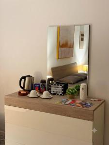 a counter with a mirror on top of a room at Room in sliema's heart in Il-Gżira