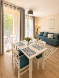 a living room with a table and chairs and a couch at Adriatic Monte Apartments in Tušupi