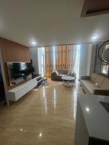 a living room with a couch and a flat screen tv at Luxury Loft at Crown Regency in Cebu City