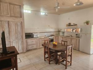 a kitchen with a table and a white refrigerator at El Ñangapiri in Mercedes