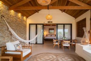 a living room with a table and a dining room at Villa Florens in Jericoacoara +238 photos