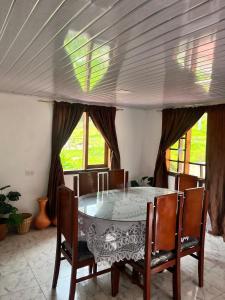 a dining room with a table and chairs at Cabaña La Colina in Sutatausa +8 photos