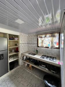 a kitchen with a sink and a stove in it at Cabaña La Colina in Sutatausa