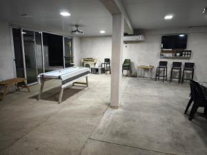an empty room with a pool table and chairs at Quincho Ruben in La Rioja