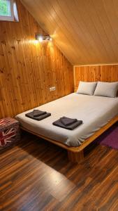 a bedroom with a large bed in a wooden room at The DACHA escape in Viimsi