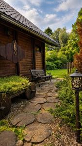 a stone path leading to a cabin with a bench at The DACHA escape in Viimsi