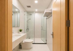 a bathroom with a shower and a toilet and a sink at Anna seaview hotel in Phú Quốc