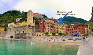 a group of people on a beach near the water at Vernazza Vacation 2 in Vernazza