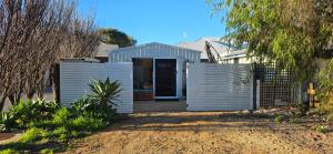 a house with a blue door in a yard at Studio in Quindalup bay in Quindalup