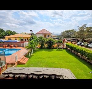 a large yard with a swimming pool next to a house at Mr smith hotel in Oyarifa