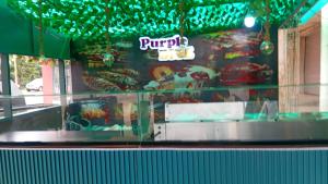 a window of a burger restaurant with green lights at Mr smith hotel in Oyarifa