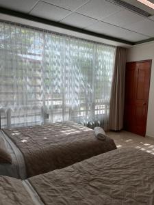 a bedroom with a bed and a large window at Ain Karem in Tuxtla Gutiérrez