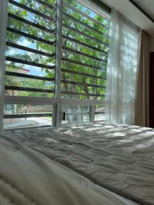 a bedroom with a bed and a large window at Ain Karem in Tuxtla Gutiérrez