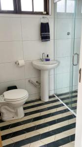 a bathroom with a toilet and a sink at Chalés Mar & Mata Paraty in Paraty