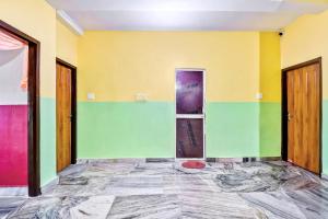 an empty room with colorful walls and doors at OYO 80514 Moody Moon in Bārang