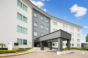 a large white building with a large entrance at Fiesta Inn Express Perinorte in Mexico City