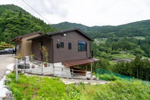 a small house on the side of a hill at Tiny House Iyashirochi Kaze in Miyoshi