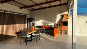 a kitchen and dining room with a wooden table and chairs at Casa da Brisa in Salinópolis