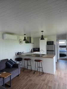 a kitchen and living room with a couch and a table at Forest View Farm Stay in Pirongia +24 photos
