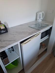 a kitchen with a counter top with a sink and a counter at Kupe Boutique House with ensuite free wifi in Whitianga +12 photos