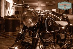 a motorcycle parked in a room with a sign on it at Privada Lodge - Historic Hotel in Kratie +32 photos