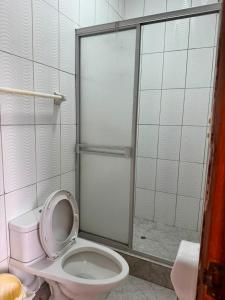 a bathroom with a toilet and a shower at Hotel Confort Amazónico in Iquitos +43 photos