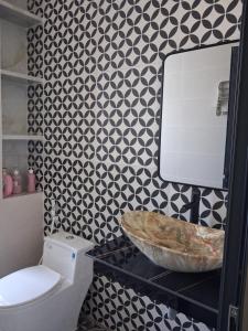 a bathroom with a white toilet and a sink at Homestay Kim Thuy in Hiếu Xương