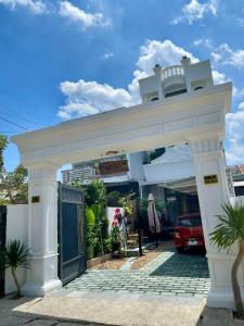a white entrance to a building with a blue door at Homestay Kim Thuy in Hiếu Xương +22 photos