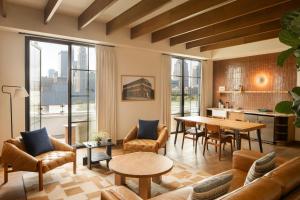 a living room with a couch and a table at The Junto Hotel in Columbus