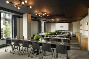 a conference room with a long table and chairs at The Junto Hotel in Columbus