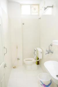 a white bathroom with a toilet and a sink at NK Homes Fully Furnished Apts in Hyderabad +36 photos