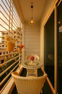 a small table and chairs on a balcony at NK Homes Fully Furnished Apts in Hyderabad