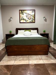a large bed in a room with two night stands at Apartamento Aura 10 in El Coco