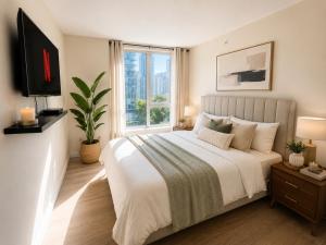 a bedroom with a large bed and a window at Walk Everywhere from This Bright 2BR Condo in Vancouver