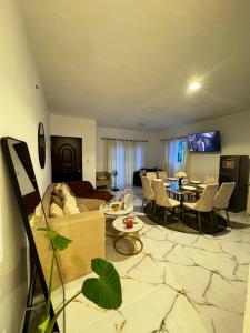 a living room with a couch and a table at Apartamentos SCARLEM in Higuey +2 photos
